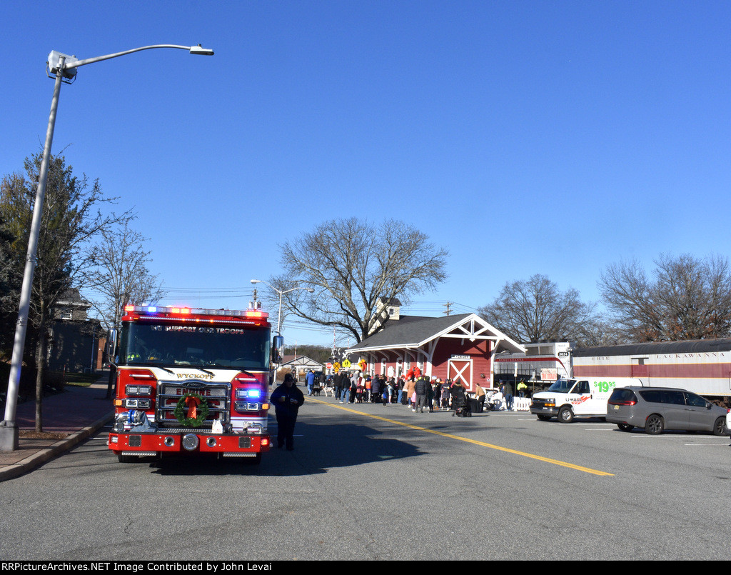 The celebration with the TFT train parked at the Wyckoff Station is in full swing with a fire truck on the left 